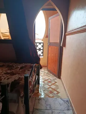 a bedroom with a bed and an arched doorway at Africa Hollywood in Aït Ben Haddou