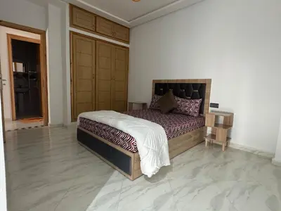 a bedroom with a large bed in a room at Luxurious apartment in Oud Fes golf city in Fès