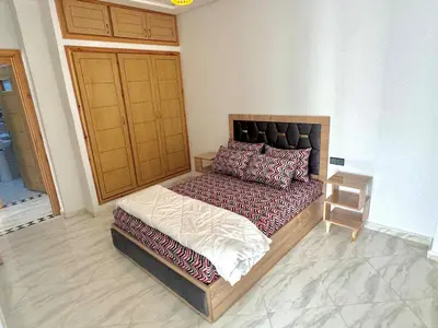 a bedroom with a large bed in a room at Luxurious apartment in Oud Fes golf city in Fès