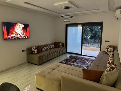 a living room with two couches and a fireplace at Luxurious apartment in Oud Fes golf city in Fès