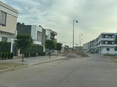 an empty street in a city with buildings at Luxurious apartment in Oud Fes golf city in Fès