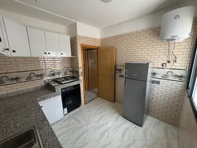 a kitchen with a refrigerator and a stove at Luxurious apartment in Oud Fes golf city in Fès