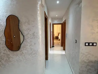a hallway with a guitar on the wall at Luxurious apartment at a low price in Meknès