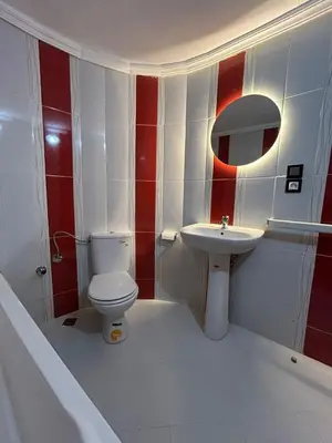a bathroom with a toilet and a sink at Luxurious apartment at a low price in Meknès
