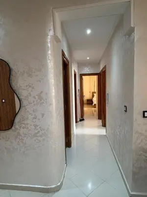 a hallway with a guitar on a wall at Luxurious apartment at a low price in Meknès