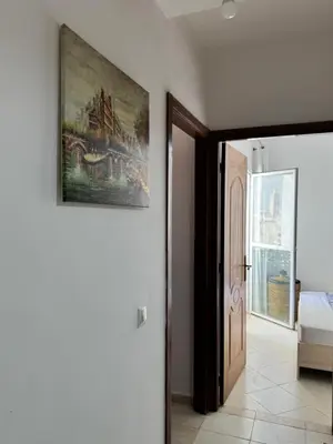 a painting hanging on a wall next to a door at Fès comfort stay in Fès