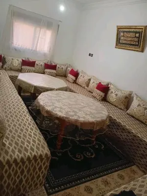 a living room with a couch and two tables at Appartement familial, plein centre d'Azilal in Azilal