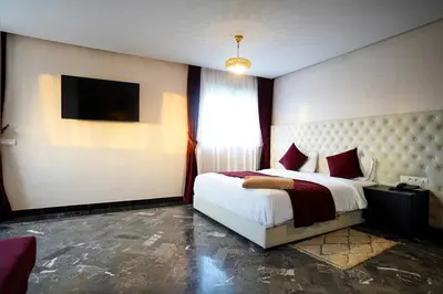 a hotel room with a bed and a television at Palais Dar Souhir in Sidi Bouzguia