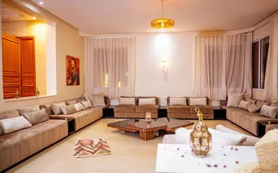 a living room with couches and a coffee table at Palais Dar Souhir in Sidi Bouzguia