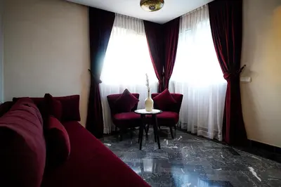 a living room with a couch and two chairs and a window at Palais Dar Souhir in Sidi Bouzguia