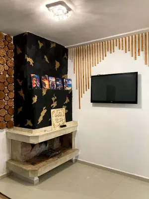 a living room with a flat screen tv on a wall at Chill unique apartment in Ifrane in Ifrane