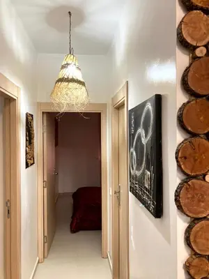 a hallway with a chandelier and a room at Chill unique apartment in Ifrane in Ifrane