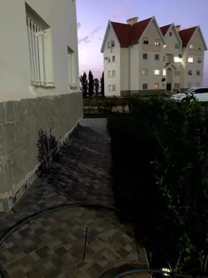 a walkway in front of a building with buildings at Chill unique apartment in Ifrane in Ifrane