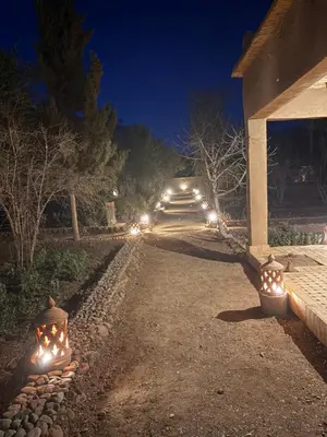 a row of lights on a walkway at night at Skoura Ranch Palm Grove in Ouarzazate