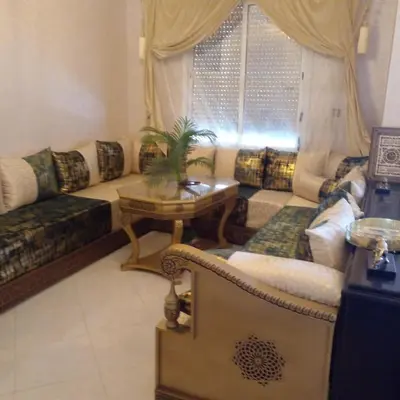 a living room with a couch and a table at Vip apartment in Fès