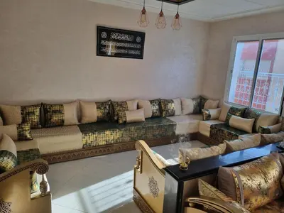 a living room with a couch and a table at Vip apartment in Fès