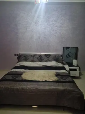a bedroom with a bed with a blanket on it at Vip apartment in Fès