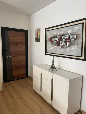 a room with a white cabinet and a painting on the wall at You'll be comfortable there! in Fès