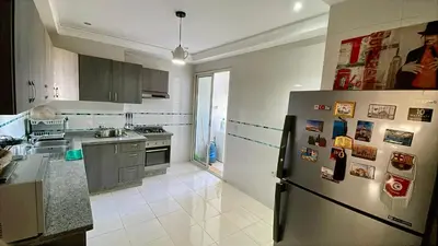 a kitchen with a stainless steel refrigerator with magnets at You'll be comfortable there! in Fès