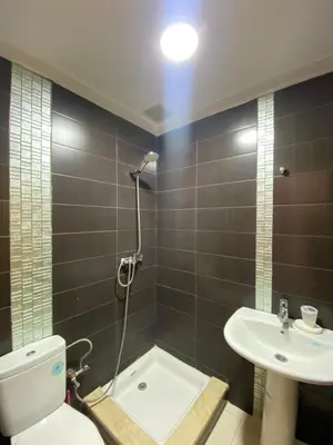 a bathroom with a shower and a toilet and a sink at You'll be comfortable there! in Fès
