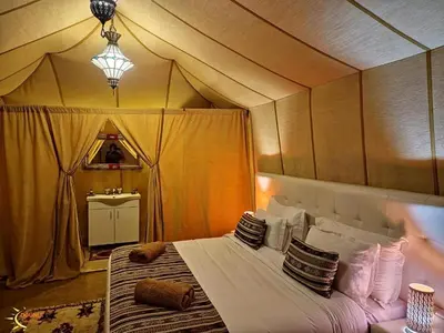 a bedroom with a bed in a tent at Starry Luxury Camp in Merzouga
