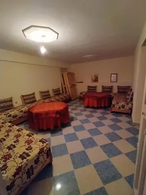a room with two beds and a checkered floor at Gite El Qalaa - مأوى القلعة in Taza