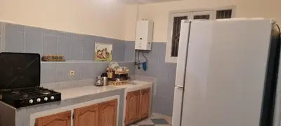 a kitchen with a white refrigerator and a stove at Gite El Qalaa - مأوى القلعة in Taza