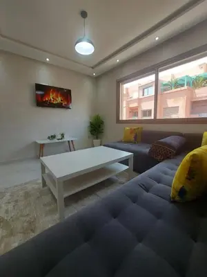 a living room with a couch and a table at Appartement centre ville in Oulad Akkou