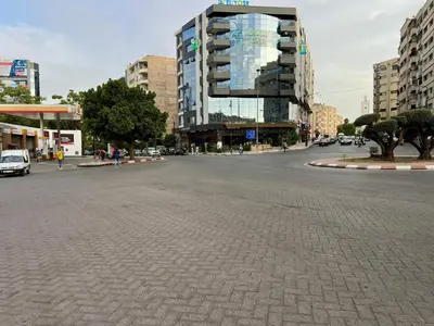 a street in a city with a tall building at Fes City Luxury Suites - Apartments & Studio in Fès