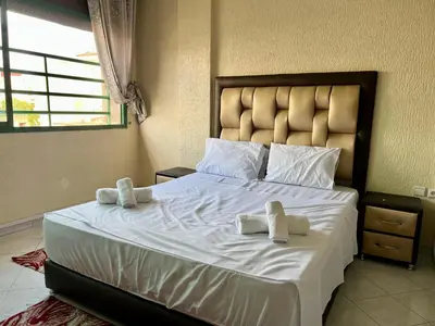 a bedroom with a large bed with towels on it at Fes City Luxury Suites - Apartments & Studio in Fès