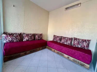 a room with a purple couch in the corner at Fes City Luxury Suites - Apartments & Studio in Fès
