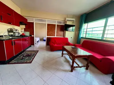a living room with a red couch and a table at Fes City Luxury Suites - Apartments & Studio in Fès