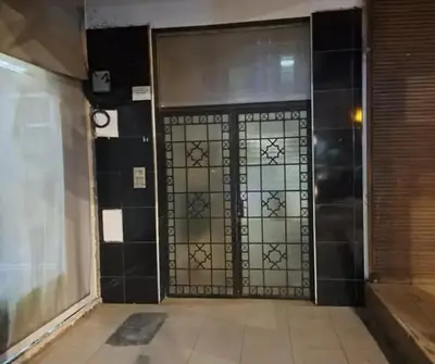 a door in a room with black and white tiles at Abdeslam in Kasba Tadla