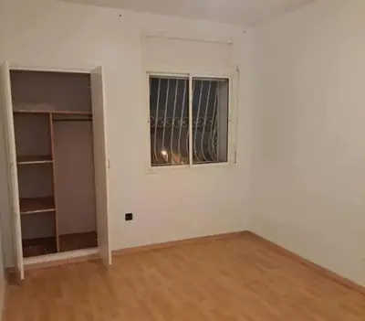 an empty room with a window and a white wall at Abdeslam in Kasba Tadla