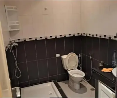 a bathroom with a toilet and a sink at Abdeslam in Kasba Tadla