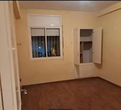 an empty room with a door and a window at Abdeslam in Kasba Tadla