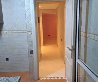 a door leading into a bathroom with a hallway at Abdeslam in Kasba Tadla