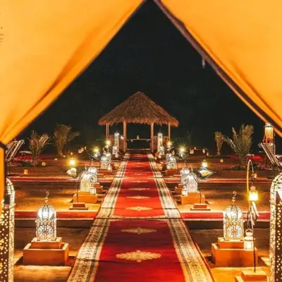 a tent set up for a wedding at night at Merzouga tente luxury in Merzouga