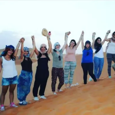 a group of women running on the beach at Merzouga tente luxury in Merzouga