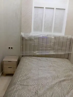 a small bedroom with a bed and a window at Quiet and central apartment in Oulad Akkou