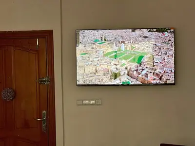 a flat screen tv hanging on a wall at Prestige Apartment - Fes Elegant Stay in Fès
