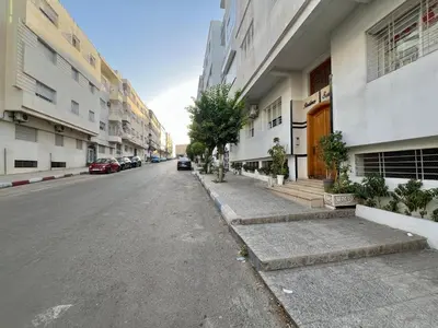 an empty street in a city with buildings at Prestige Apartment - Fes Elegant Stay in Fès