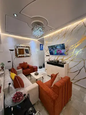 a living room with two couches and a tv at Appartement Luxe Simo 2 in Fès
