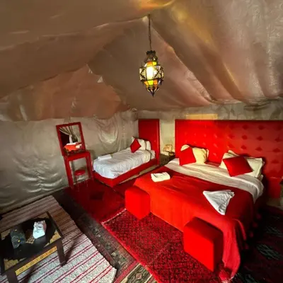 a bedroom with two beds in a tent at Merzouga Stars Camp in Merzouga
