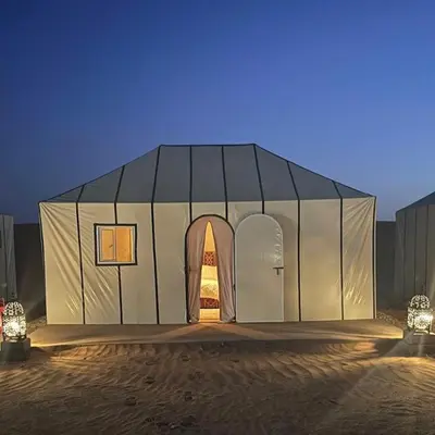 a white tent with an open door in the desert at Merzouga Stars Camp in Merzouga