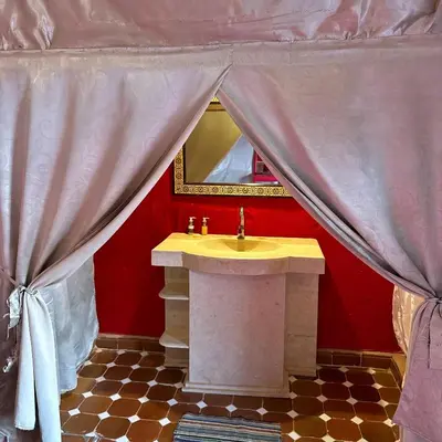a bathroom with a sink and a mirror at Merzouga Stars Camp in Merzouga