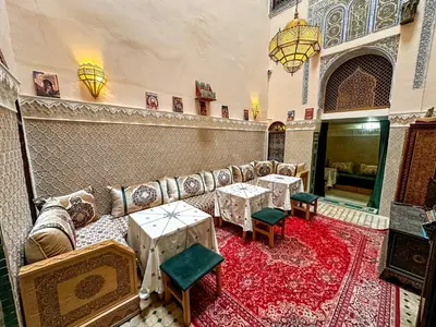 a living room with a couch and tables in a room at Riad Sufi House Fes in Fès