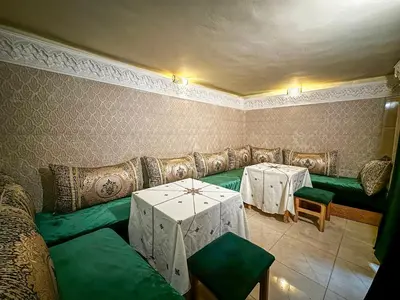 a living room with two tables and a couch at Riad Sufi House Fes in Fès