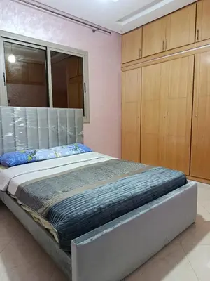 a large bed in a room with wooden cabinets at Dar araha in Fès