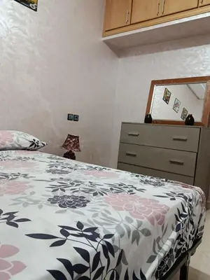 a bedroom with a bed and a dresser at Dar araha in Fès